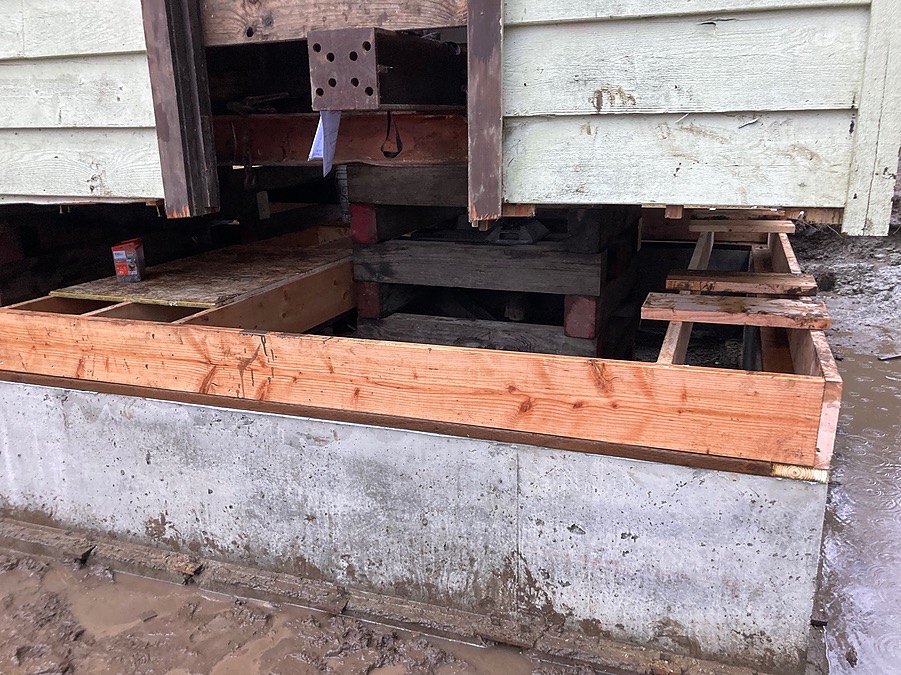 Detail of the temporary cribbing and new foundation ledger under the small building