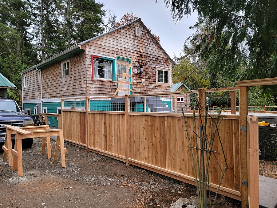 The finished house from the street, with new cedar fence