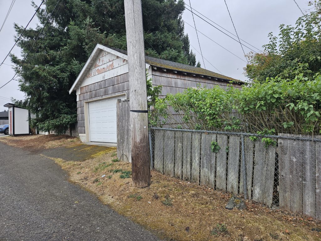 The garage today, from the alley, showing the original weathered siding