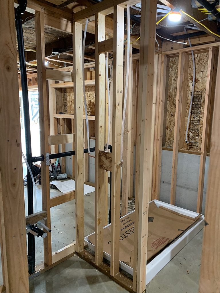 Bathroom framing and shower pan rough-in in the new basement apartment