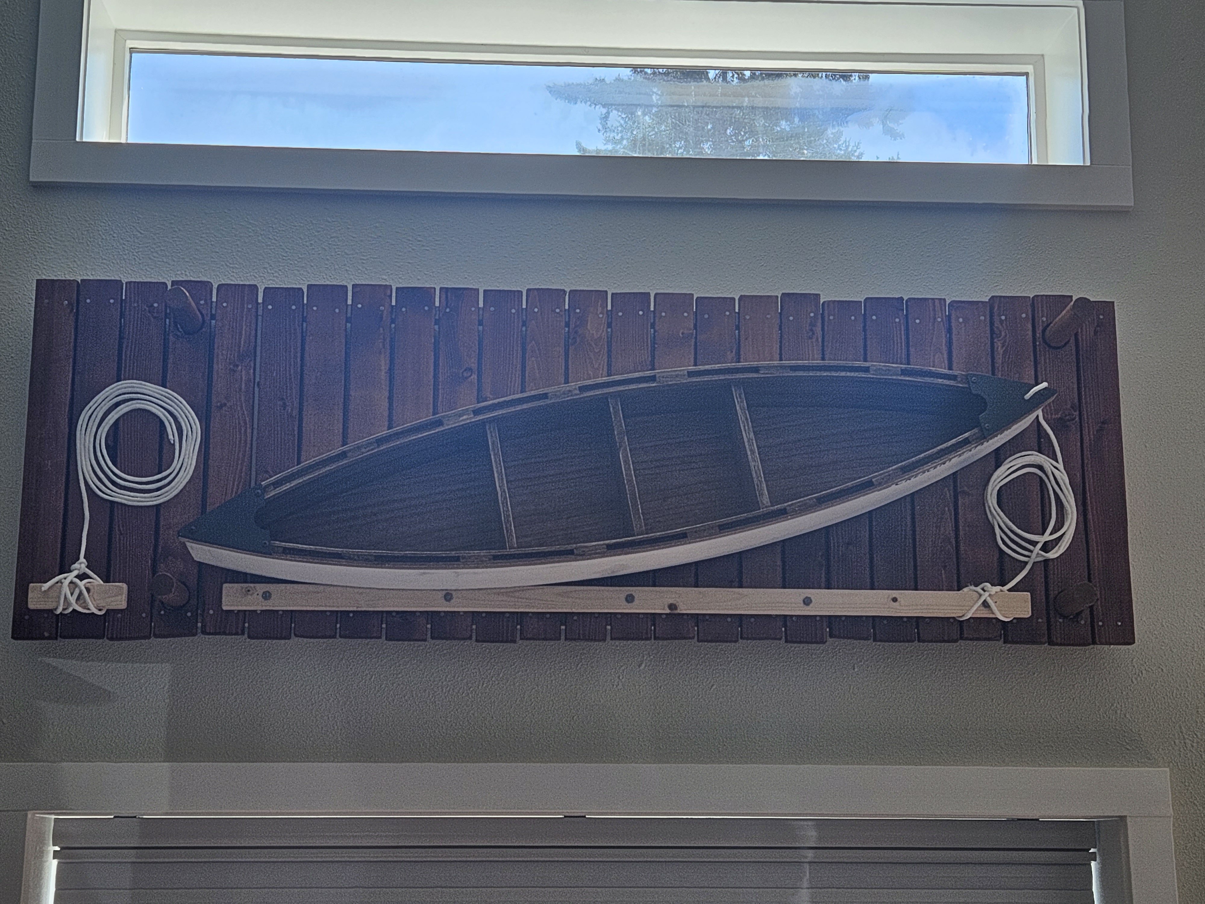 Guest suite feature wall with a canoe named Crescent Explorer mounted on reclaimed timber
