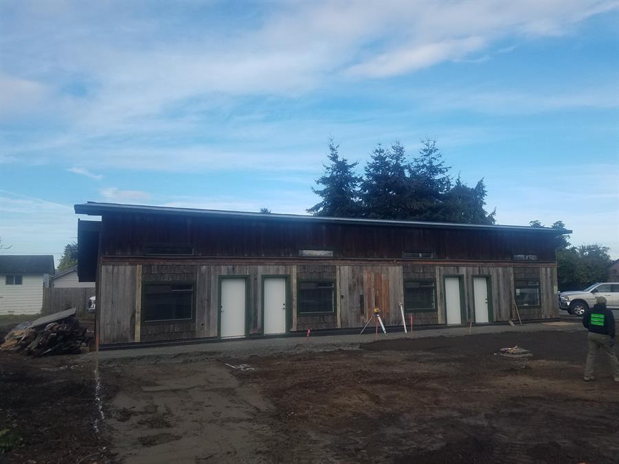 The building stripped back to its frame during renovation, with the roof reframed and new openings cut