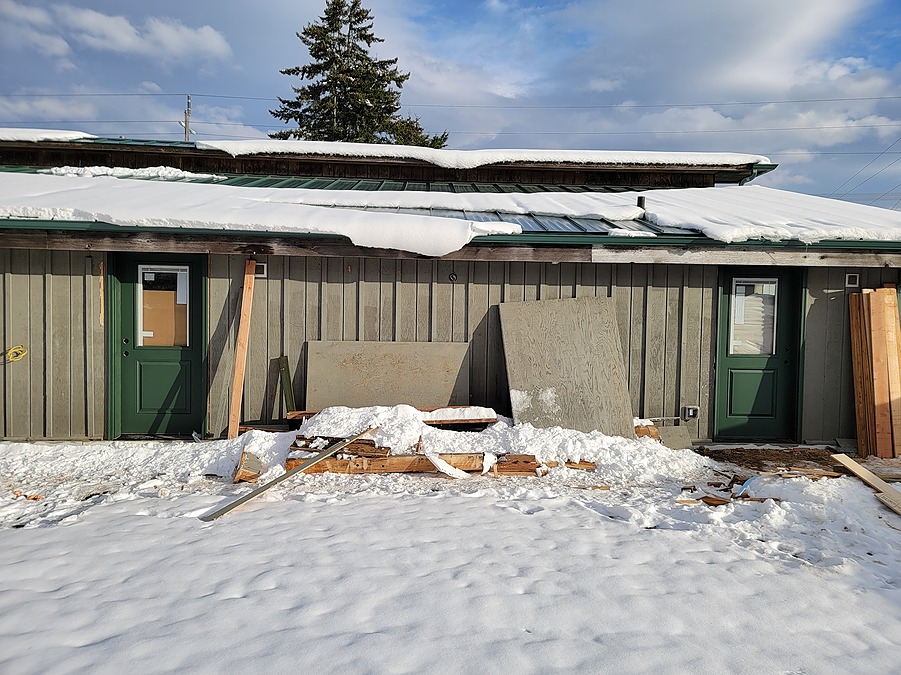 Renovation work continuing through winter snow, with new green suite doors installed