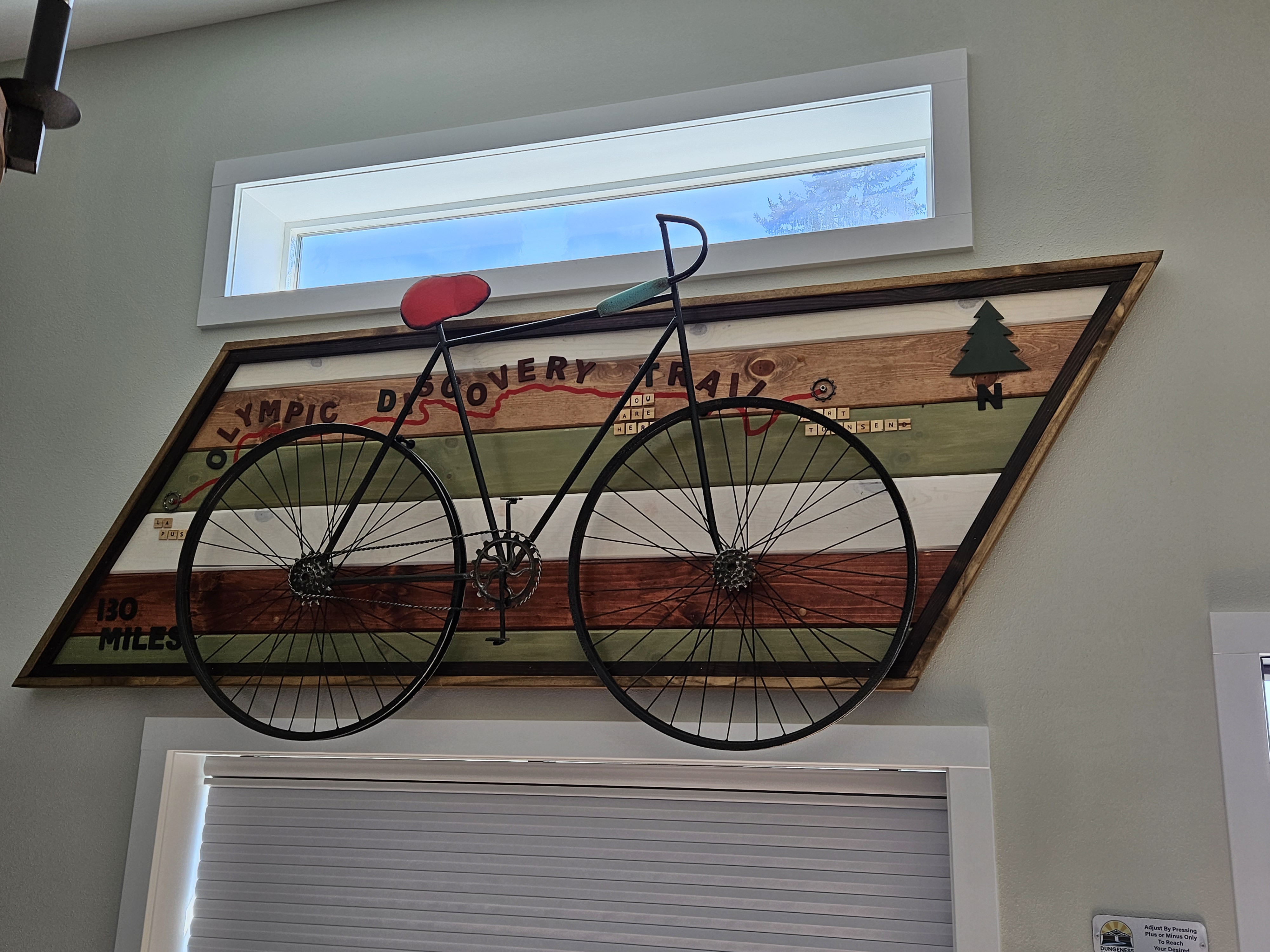 Guest suite interior with a bicycle mounted on an Olympic Discovery Trail mural
