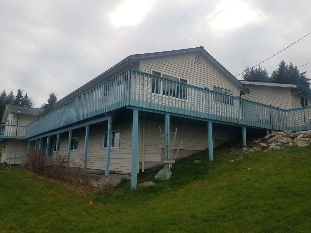 Weathered painted deck on a Bell Hill home before replacement