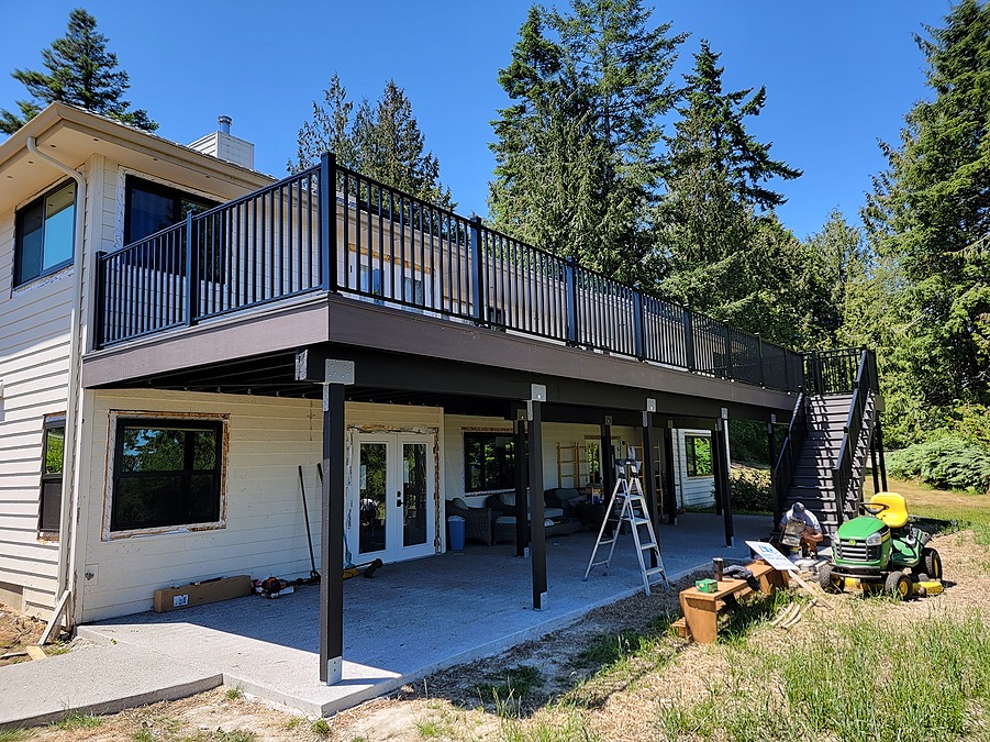 Elevated low-maintenance deck with black aluminum railing on a Bell Hill home in Sequim