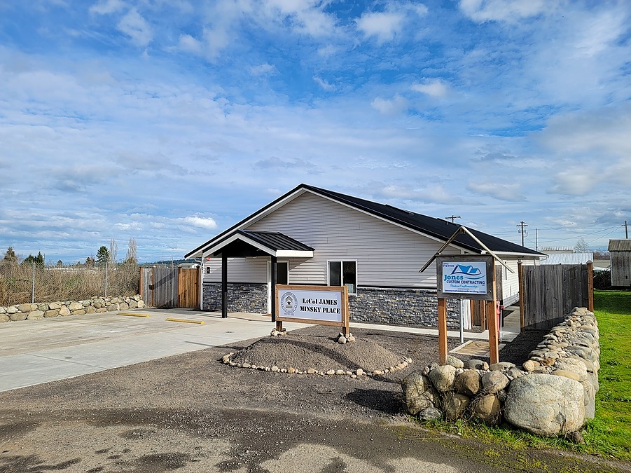Veterans housing in Sequim, Washington after conversion, with a new standing seam metal roof, stone veneer and covered entry